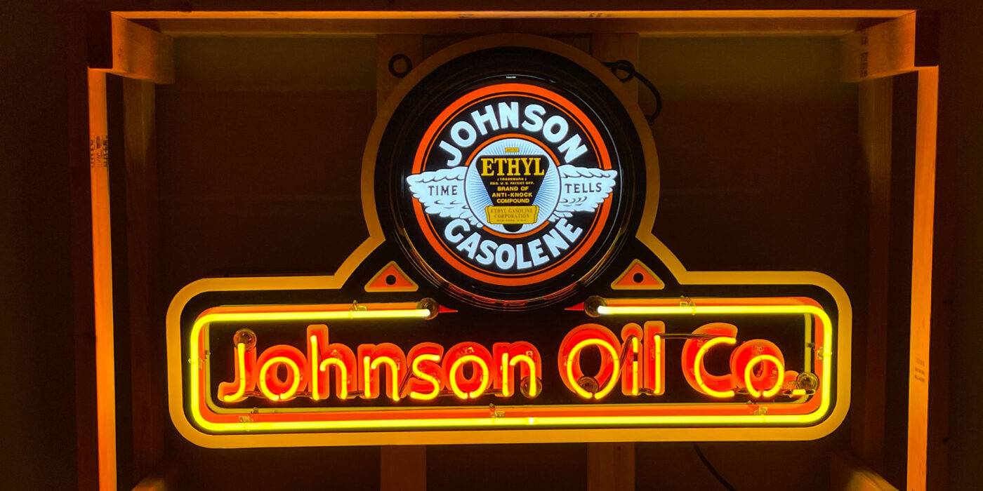 Neon road johnson oil co gasolene sign lit up