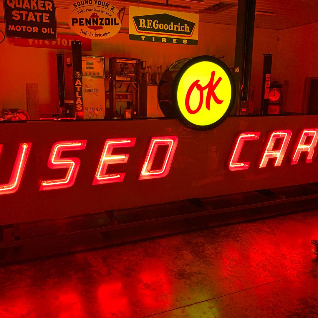 Neon road ok used cars sign lit on