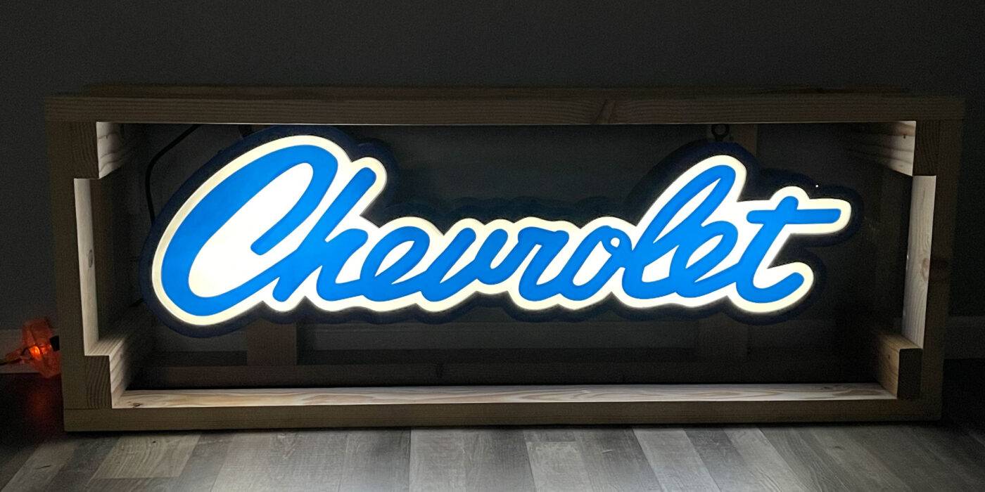Neon road scripted chevrolet sign
